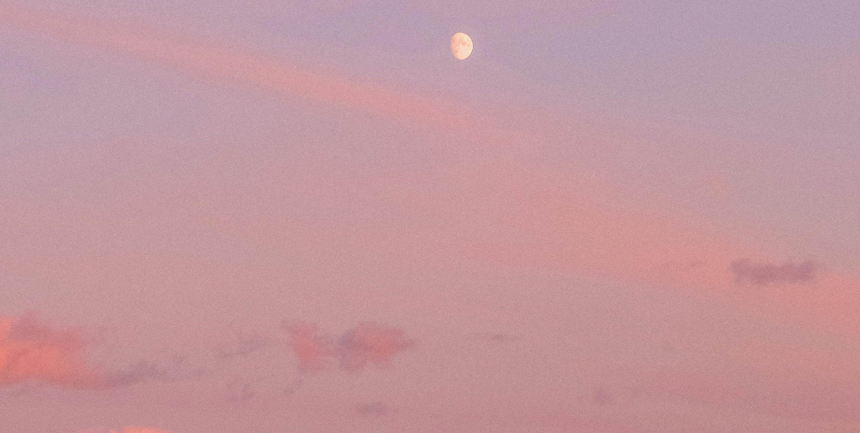 Rosy sunset sky and a small visible moon, symbolizing events for spiritual connection in beautiful places.